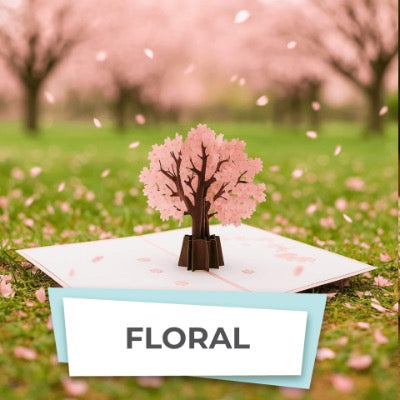 Pop-up card with cherry blossom tree design on a grassy field background
