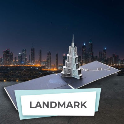 Pop-up card with a 3D model of a skyscraper against a city skyline at night.